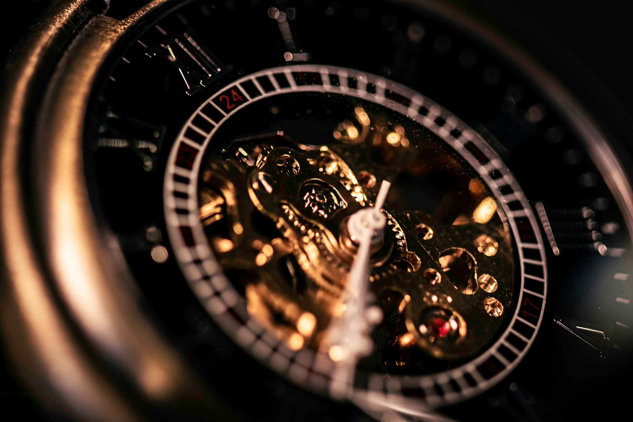 Black and gold mechanical chronograph in dramatic light